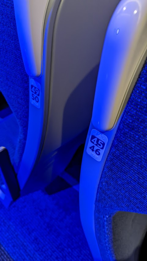 Image showing stickers on a Pendolino train seat, which the seat numbers in both text and braille.