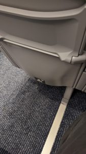 Image shows a 3-pin UK plug socket, and a USB socket, in the back of a seat on a Pendolino train.